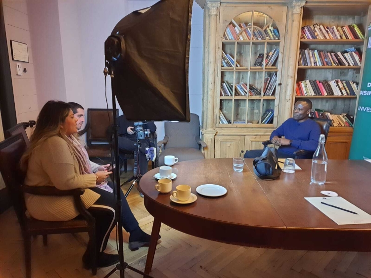 A photo of James Okong'o being interviewed in an office. 