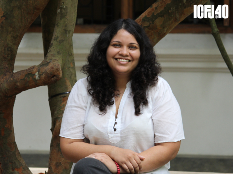 A photo of Raisa Wickrematunge sitting for a headshot.