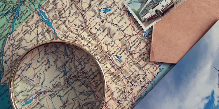 A close-up photo of a magnifying glass on a map. 