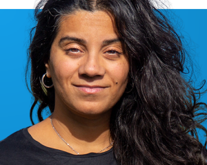 Portrait of Nabeelah on blue background